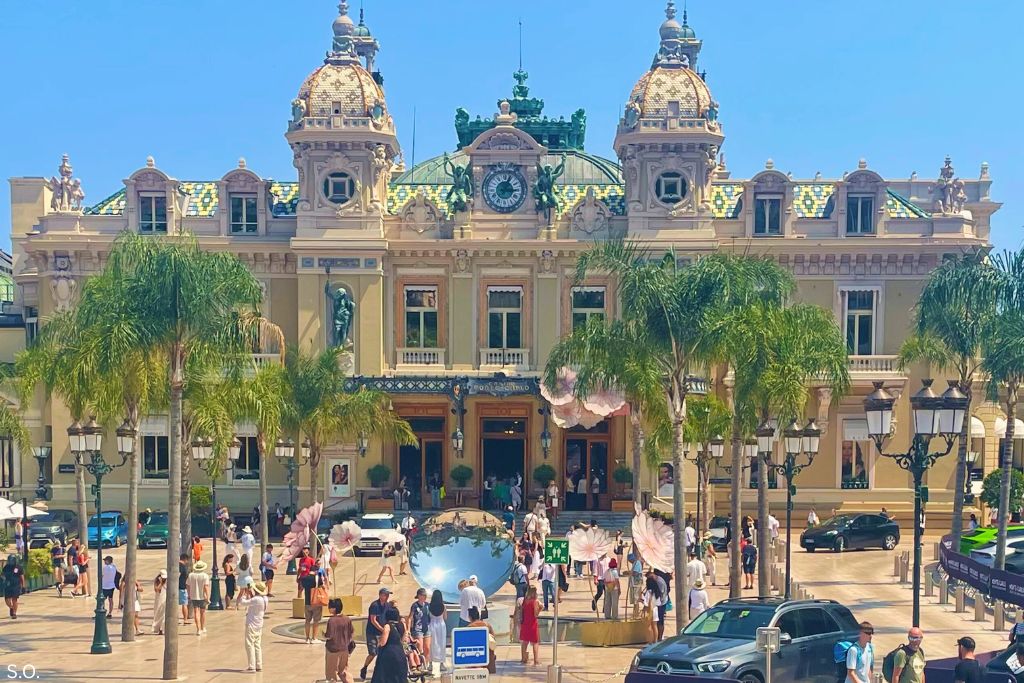 The iconic Monte Carlo Casino in Monaco, featuring its grand Belle &Eacute;poque architecture and lush gardens, under a clear blue sky