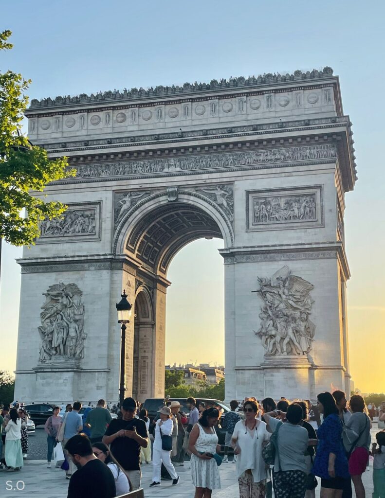 The monumental Arc de Triomphe stands proudly at the center of Place Charles de Gaulle, honoring French military victories.