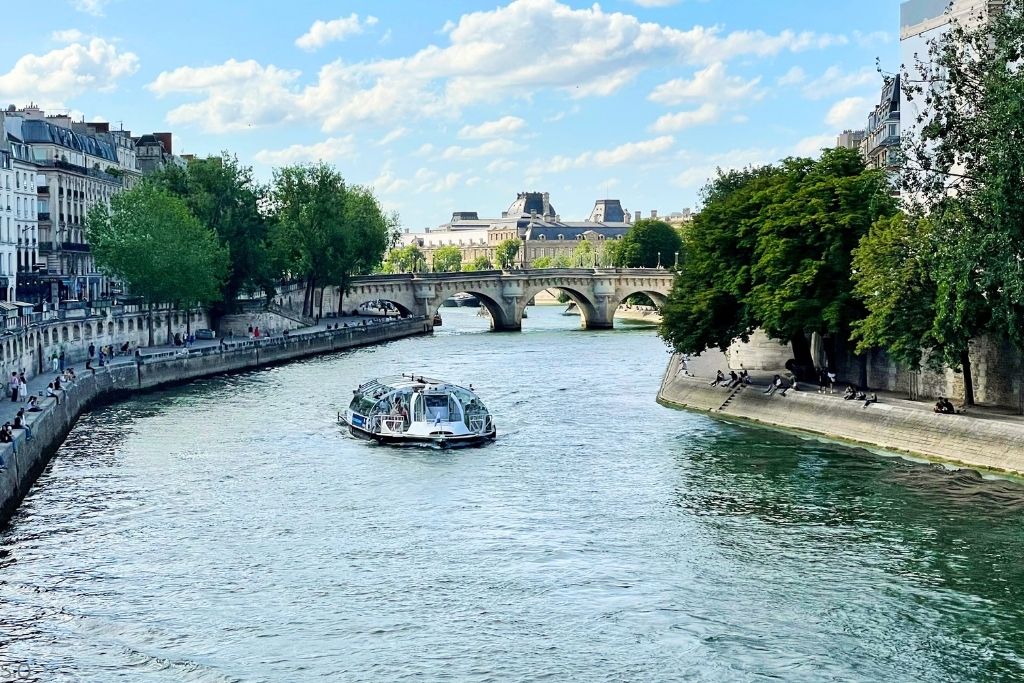 The historic Pont Neuf, Paris' oldest standing bridge, gracefully spanning the Seine River with its elegant arches and iconic stonework.