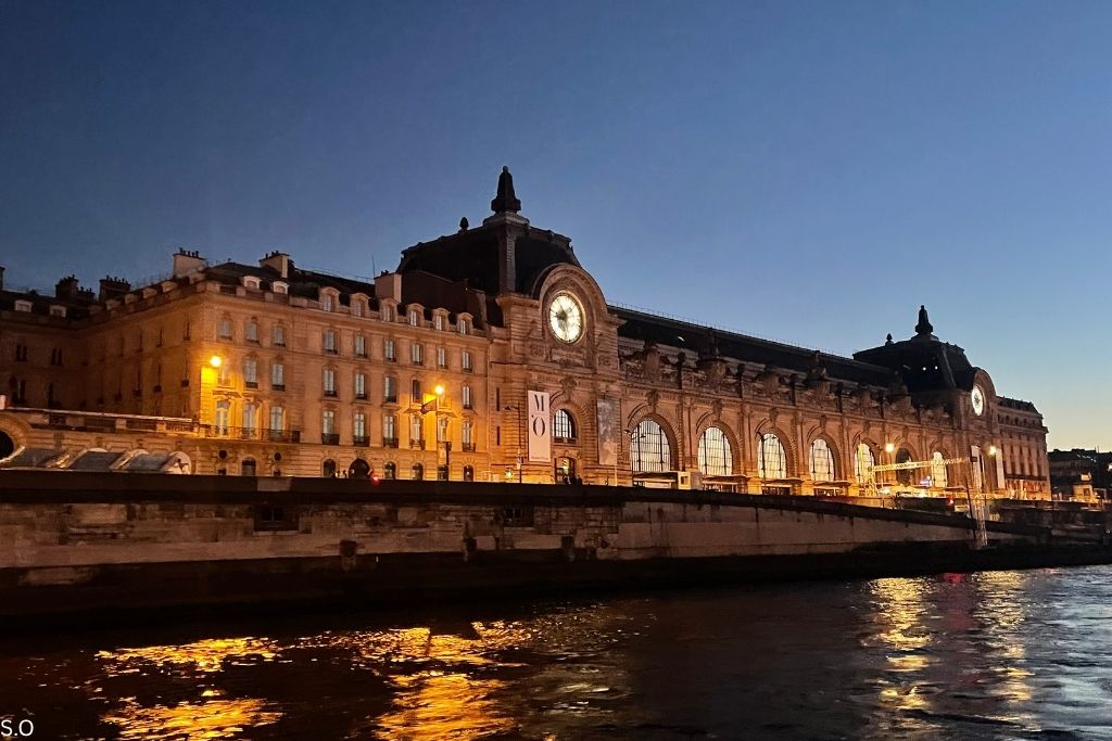 The grand Mus&eacute;e d'Orsay, a former train station turned art museum, featuring its iconic clock and riverside location.