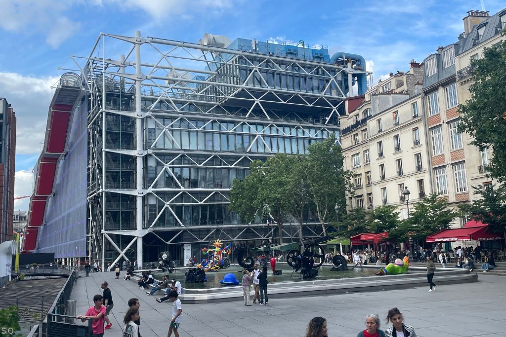 A view of the Center Pompidou in Paris with colorful exposed pipes and contemporary modern architecture.