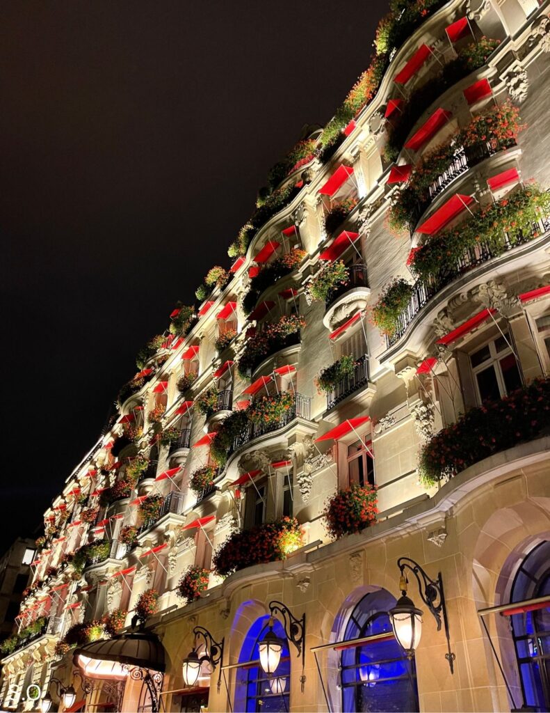 Hôtel Plaza Athénée glowing at night with elegant façade lights